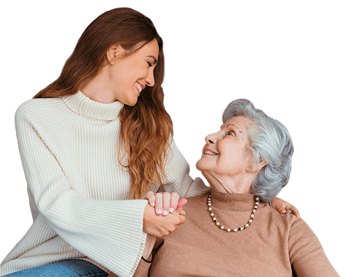 Una imagen sin fondo de una cuidadora con una mujer mayor en la que se están cogiendo las manos y mirándose entre ellas de manera cariñosa.